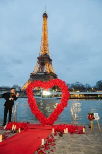 Man playing violin with flowers candles