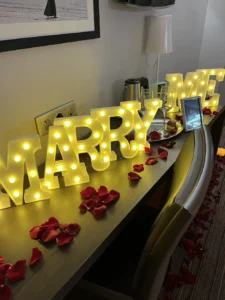 Table with glasses photo frame and lights