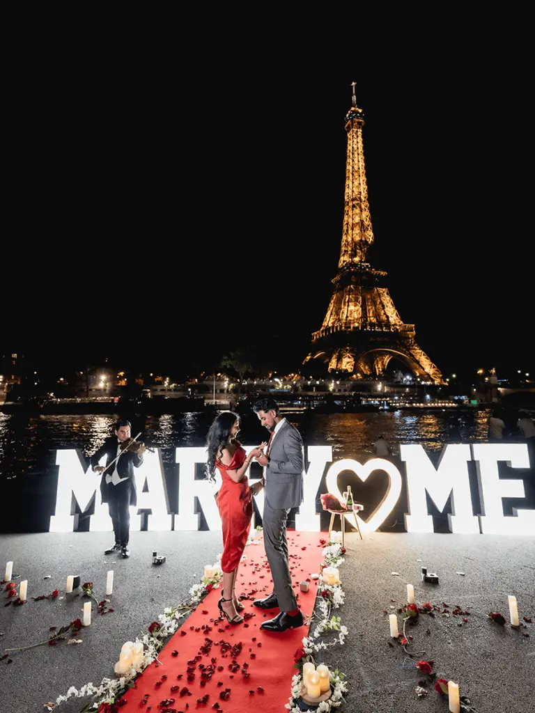 Couple on red carpet with flowers candles