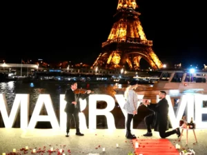 Three people with violinist by water