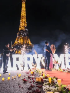 Couple on floor with candles flowers Eiffel Tower