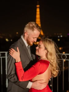 Couple holding each other with tower fence