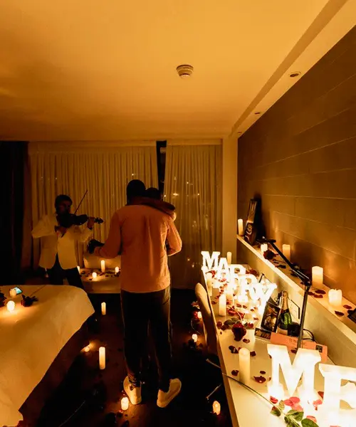 Two people standing by table