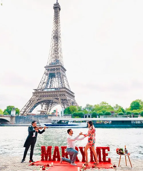 Three people by water with boat