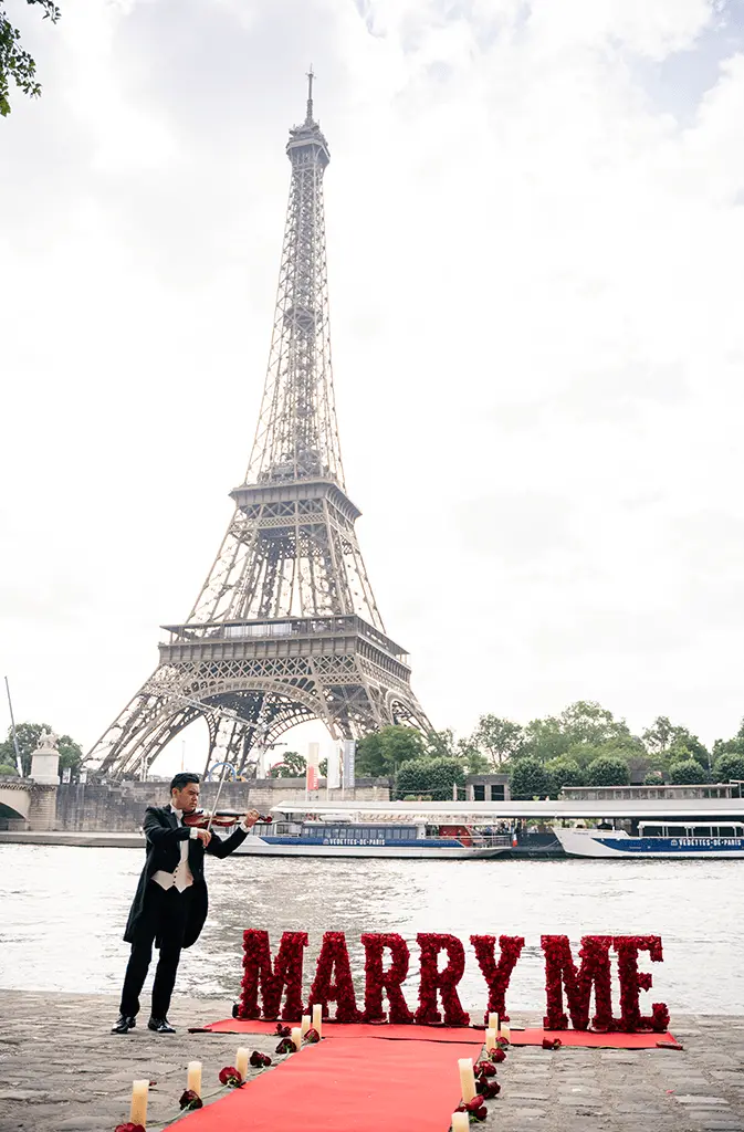 Person in black holding musical instrument