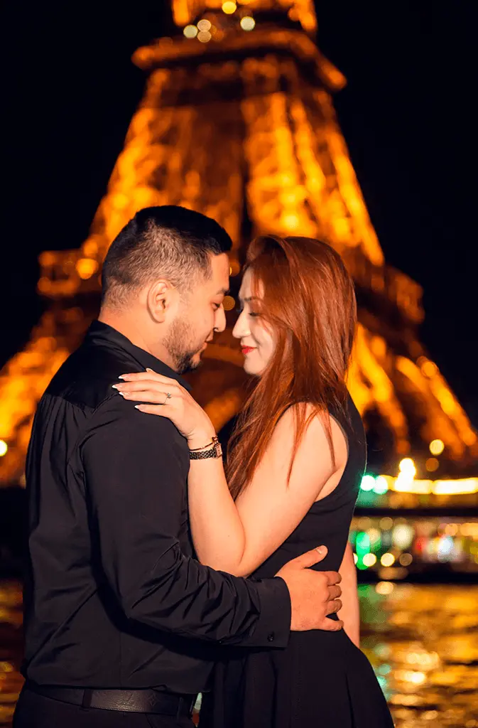 Couple standing with tower and lights